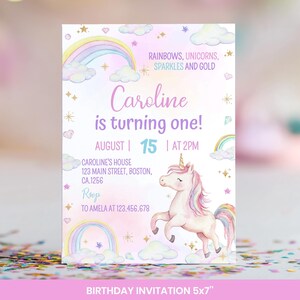 May include: A rectangular birthday invitation card featuring a white background with pastel rainbows, clouds, gold stars, and a unicorn. The text reads: RAINBOWS, UNICORNS, SPARKLES AND GOLD, Caroline is turning one!, AUGUST 15 AT 2PM, and address details.