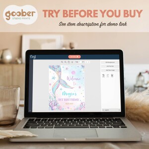 May include: A computer screen displaying a mermaid-themed birthday party invitation design in a digital design program. The design features a mermaid tail, seashells, and stars. The text on the invitation reads "Welcome to Mayra's 1st Birthday".