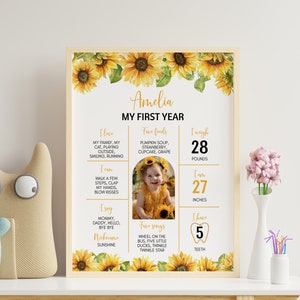 May include: A yellow and green first birthday milestone poster with a sunflower theme. The poster features a photo of a baby girl, along with details about her first year, including her weight, height, favorite foods, and songs. The text on the poster reads "Amelia My First Year".