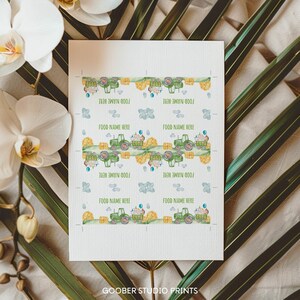 May include: Printable food labels featuring a green tractor with hay bales and blue balloons. The labels say "Food Name Here" repeated eight times.