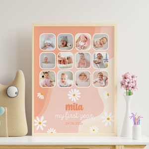 May include: A framed baby milestone photo collage. The collage features twelve small square photos of a baby, arranged in a grid. The background is peach with white daisy accents and the text "mila my first year" in a soft orange font.