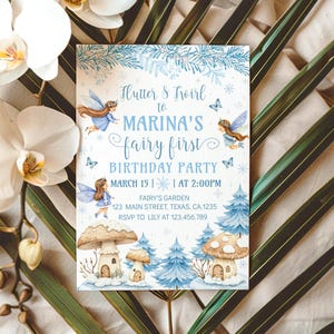 May include: A light blue invitation for "Marina's fairy first birthday party." The invitation features illustrations of fairies, mushrooms, and trees. The text includes the date, time, and location: Fairy's Garden, 123 Main Street, Texas, CA 1235.