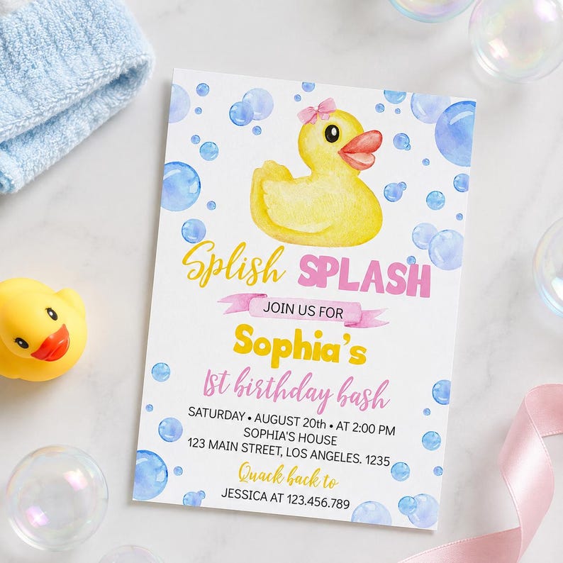 May include: A rectangular birthday invitation card featuring a yellow rubber duck with a pink bow, blue watercolor bubbles, and the text Splish SPLASH JOIN US FOR Sophia's 1st birthday bash SATURDAY AUGUST 20th AT 2:00 PM SOPHIA'S HOUSE 123 MAIN STREET LOS ANGELES 1235 Quack back to JESSICA AT 123.456.789.