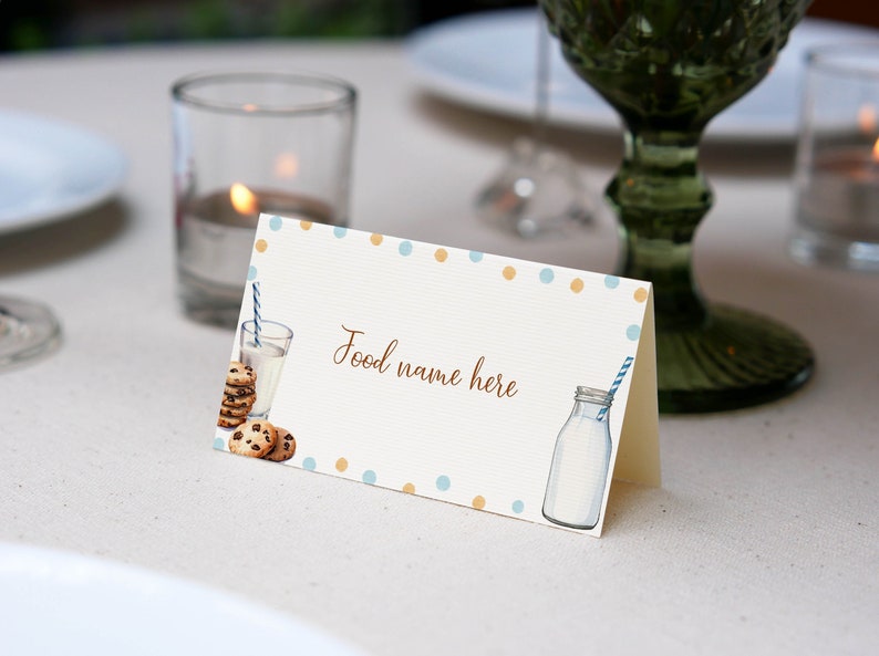 May include: A white card with blue and orange polka dots. The card has a picture of a glass of milk with a straw, a bottle of milk with a straw, and chocolate chip cookies. The text on the card says "Food name here".