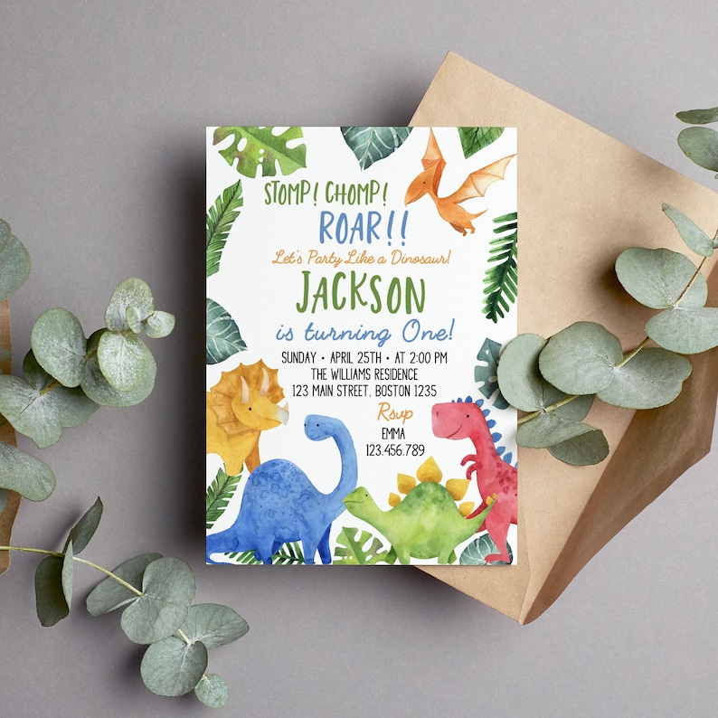 May include: A rectangular invitation card featuring watercolor illustrations of a yellow triceratops, a blue long-necked dinosaur, a green stegosaurus, a red dinosaur, and an orange pterodactyl surrounded by green tropical leaves and text.