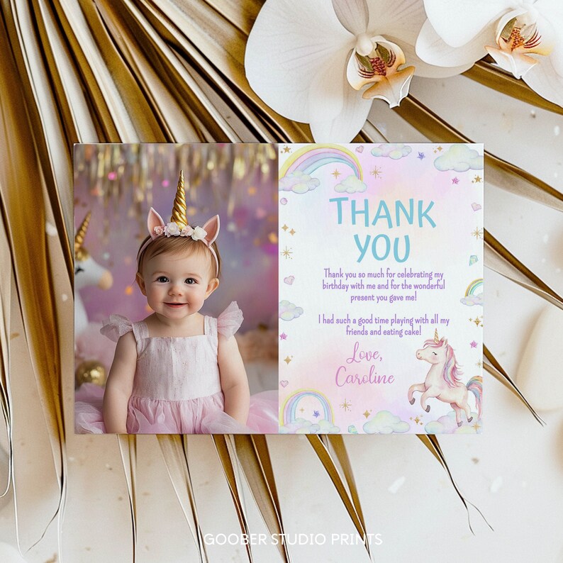 May include: A rectangular thank you card featuring a photograph of a child wearing a gold unicorn horn headband on the left side. The right side displays pastel rainbow, cloud, and unicorn illustrations with the text Thank You and Love, Caroline.