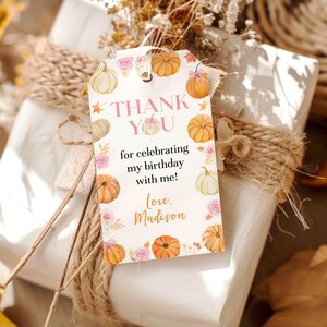 May include: A rectangular white gift tag featuring watercolor illustrations of orange pumpkins and pink roses. The text reads: THANK YOU for celebrating my birthday with me! Love, Madison. The tag has a hole at the top for hanging.