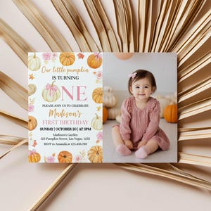 May include: A first birthday invitation with a photo of a baby girl in a pink dress. The invitation features pumpkins, flowers, and the text "Our little pumpkin is turning ONE." The event is on Sunday, October 20th, at 3 PM.