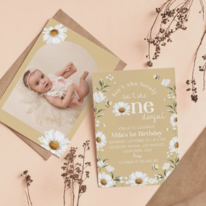 May include: A first birthday invitation card featuring white daisy illustrations, small bees, and the text "Isn't she lovely, isn't she one-derful, join us to celebrate Mila's 1st birthday, Saturday, October 20, at 2 PM, 125 Peony Avenue, Los Angeles, California, 1254, RSVP to Emma at 123.456.789."