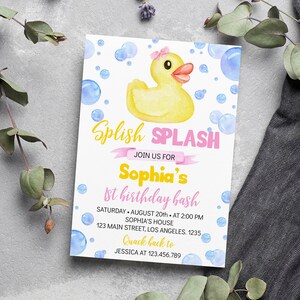 May include: A rectangular invitation card featuring a yellow rubber duck with a pink bow, surrounded by blue watercolor bubbles. The text reads: Splish SPLASH JOIN US FOR Sophia's 1st birthday bash SATURDAY AUGUST 20th AT 2:00 PM SOPHIA'S HOUSE 123 MAIN STREET, LOS ANGELES. 1235 Quack back to JESSICA AT 123.456.789.