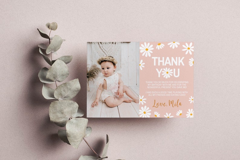 May include: A pink thank you card with white daisies and gold lettering. The card says "Thank You" and "Love, Mila". A photo of a baby girl wearing a white dress and a flower crown is in the background.