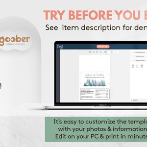 May include: A laptop screen displays a digital template for a first birthday party invitation featuring a winter forest graphic with blue pine trees and a deer. The interface includes editing tools and text fields for nutrition facts and party details.