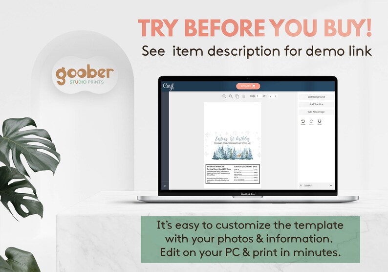 May include: A laptop screen displays a digital template for a first birthday party invitation featuring a winter forest graphic with blue pine trees and a deer. The interface includes editing tools and text fields for nutrition facts and party details.
