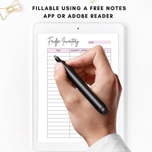 May include: A digital tablet displaying a printable fridge inventory list. The list has columns for item, quantity, expiry date, and notes. A hand is holding a black marker pen and writing on the tablet screen.
