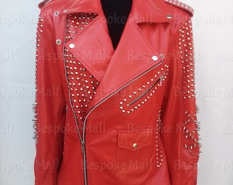 May include: Red leather jacket with silver studs on the shoulders, sleeves, and front. The jacket has a zipper closure and a slanted pocket on the left side.