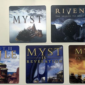 May include: Five square coasters featuring artwork and titles from the Myst video game series: Myst, Riven: The Sequel to Myst, Myst III Exile, Myst IV Revelation, and Myst V End of Ages. Each coaster displays a unique scene from the game.