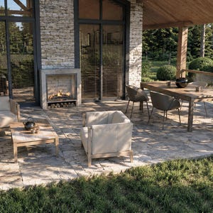 May include: An outdoor patio featuring a stone fireplace, seating, and dining areas. The seating includes a sofa, armchairs, and a coffee table. A wooden table and chairs make up the dining area. The patio is surrounded by lush greenery.