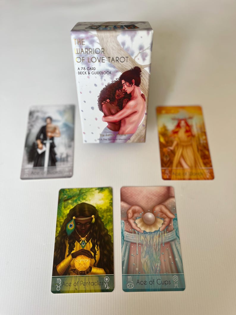 Puede incluir: Una baraja de cartas de tarot titulada "The Warrior of Love Tarot" con una caja que presenta una ilustraci&oacute;n de dos figuras abraz&aacute;ndose. Se muestran varias cartas de tarot, incluyendo "Ace of Pentacles" y "Ace of Cups". La baraja incluye 78 cartas y una gu&iacute;a.