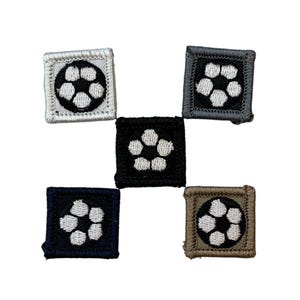 May include: Five square patches with a soccer ball design. The patches are in various colors: white, black, navy blue, gray, and brown. Each patch features a white soccer ball design on a colored background.