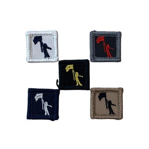 May include: Five square embroidered patches. Each patch features a figure holding a flag. The patches are in various colors: white, gray, black, navy, and tan. The flag and figure are in contrasting colors on each patch.