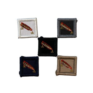 May include: Five embroidered patches with a red and gold fish design. The patches are square and have different colored backgrounds: white, black, navy blue, gray, and tan. The fish is angled diagonally across the patch.