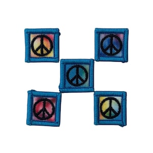 May include: Five square patches with a peace symbol. Each patch has a black peace sign on a colorful background, framed by a blue border. The patches are arranged in a cross shape against a white background.