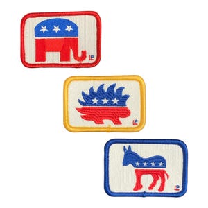 May include: Three embroidered iron-on patches featuring political party symbols. The first patch is red, white and blue and depicts an elephant. The second patch is yellow, white and blue and depicts a porcupine. The third patch is blue, white and red and depicts a donkey.