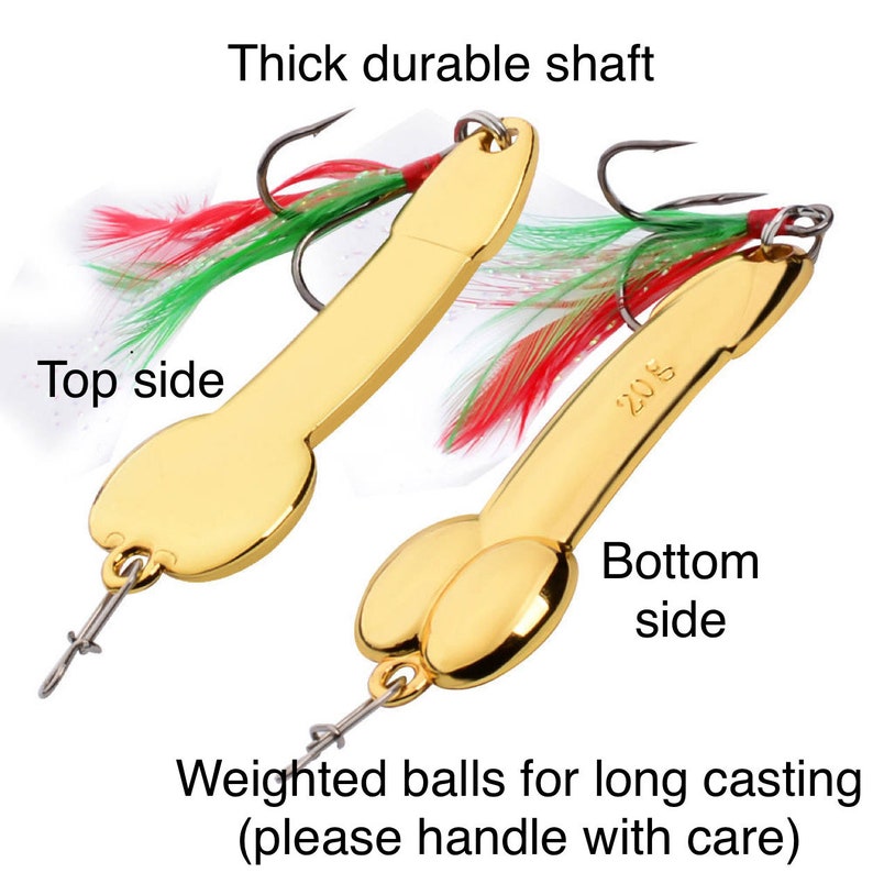 May include: Two gold fishing lures with red and green feathers. The lures have weighted balls for long casting. The text "Thick durable shaft" and "Weighted balls for long casting (please handle with care)" is visible. The text "208" is visible on one of the lures.
