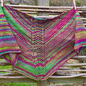 Hand knitted triangular, patterned shawl in hand dyed 4ply 75 British wool/25% nylon in summer heather moorland shades of pink and green