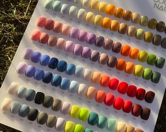 May include: A white card with a grid of small, round, colored nail polish samples. The card is labeled "Best Color Combination" and "Very Good Nail".