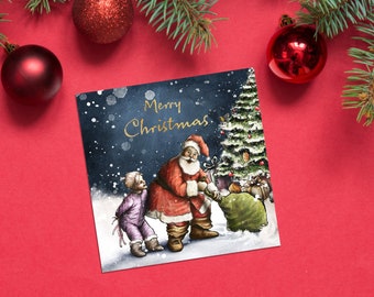 May include: A Christmas card featuring a watercolour illustration of Santa Claus giving gifts to two children under a decorated Christmas tree. The card has a blue background with white snowflakes and the text "Merry Christmas" in gold lettering.