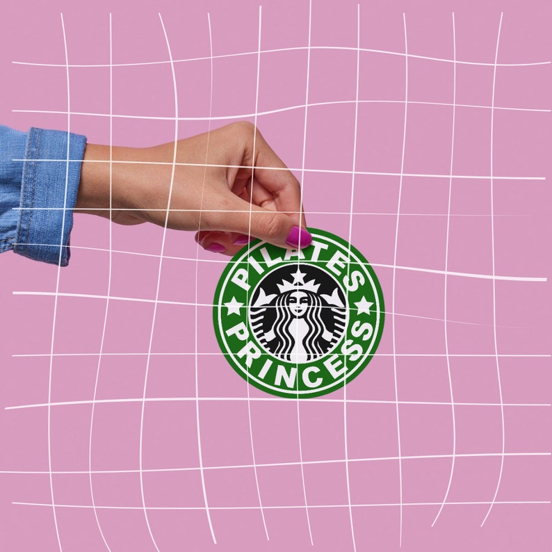 May include: A hand holding a green and white sticker with the text "Pilates Princess" and a stylized image of a mermaid with a crown.