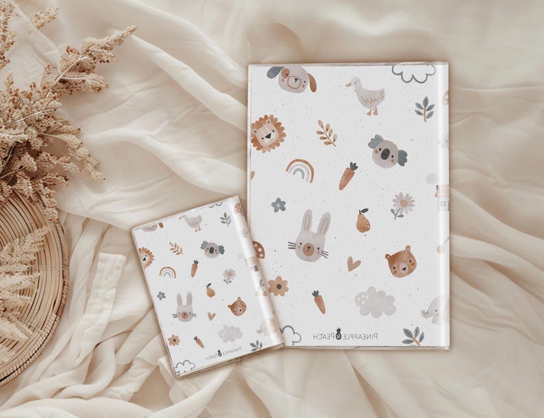 May include: Two white notebooks with a colorful pattern of animals, flowers, and rainbows. The larger notebook has the text "Pineapple & Peach" on the bottom.