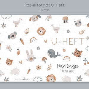 May include: A white background with a pattern of various animals, including a duck, a lion, a tiger, a koala, a rabbit, and a whale. The text "U-HEFT" is in the center of the image, with the name "Max Dages" and the date "28.10.2021" below it. The text "PINEAPPLE PEACH" is at the bottom of the image. The image is 297 mm wide and 210 mm high.