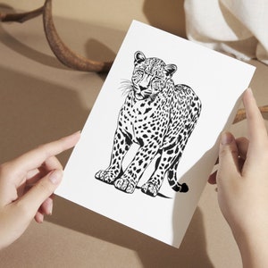 May include: Black and white line art print of a jaguar standing with its head turned to the side. The jaguar has a spotted coat and a long tail.