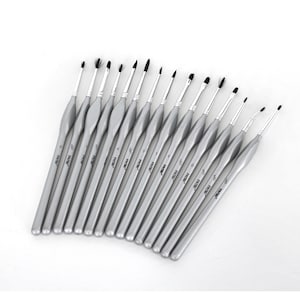 May include: Set of 15 silver paint brushes with black bristles. The brushes are arranged in a fan shape with the handles pointing to the right. The handles are labeled with numbers from 0 to 12.