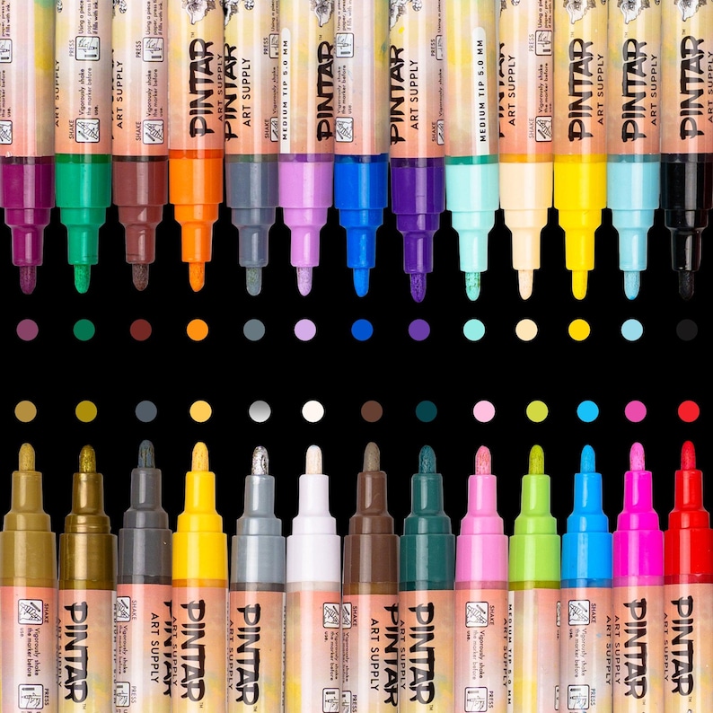 May include: A collection of Pintar Art Supply markers in various colors, including purple, green, orange, and blue. The markers have a medium tip and are arranged against a black background. The brand name and product details are visible on the marker barrels.