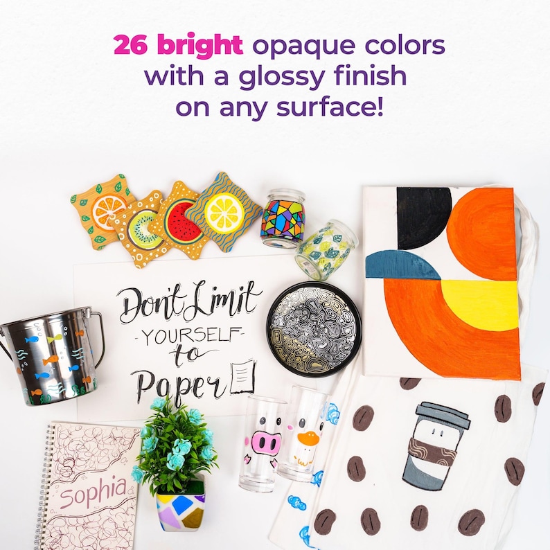 May include: An assortment of colorful art supplies and decorative items, including coasters with fruit designs, a small potted plant, and a canvas with geometric shapes. The text reads "26 bright opaque colors with a glossy finish on any surface!" and "Don't Limit Yourself to Paper."