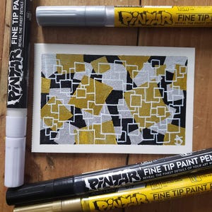 Gold and silver paint pens in a vibrant metallic finish.