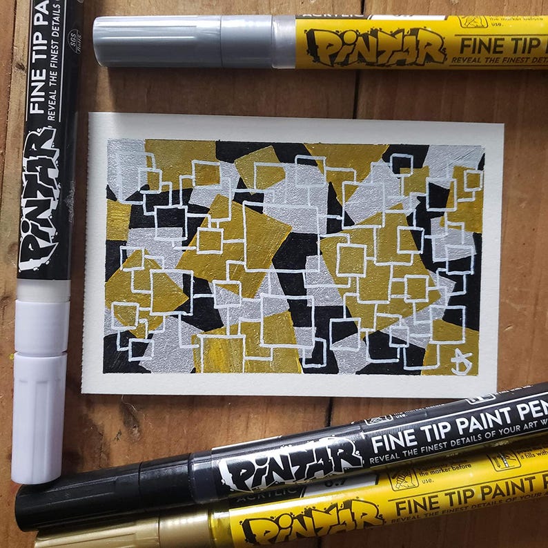 Gold and silver paint pens in a vibrant metallic finish.