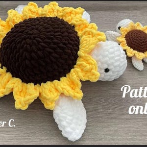 May include: Crocheted sunflower turtle with yellow petals, a brown center, and white accents. A smaller matching turtle is also present. The text "Pattern only!" is visible.
