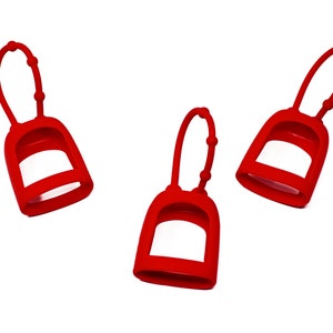 May include: Three red silicone hand sanitiser holders with a loop for carrying.