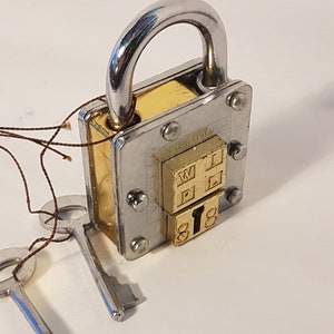 Pad lock, antique 2 key puzzle lock. Functional padlock with tricky hidden keyhole. Collectible vintage design chrome & brass details.