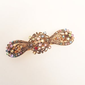 Vintage rhinestone hairclip barrette. Antique silver finish hair jewelry. Bow shaped hair clip studded with colorful stones. 3.75 inches.
