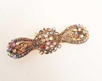 Vintage rhinestone hairclip barrette. Antique silver finish hair jewelry. Bow shaped hair clip studded with colorful stones. 3.75 inches.