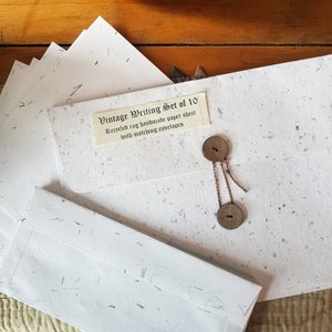 Handmade rag paper stationery gift set containing 10 paper sheets 8 by 11 inches & 10 envelopes. Paper flecked with natural leaf fiber.