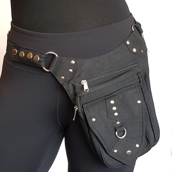 Utility pocket belt black. Adjusts to 48 inches waist/ hip. Convertible to shoulder bag. Black hip belt with 5 pockets, including 3 zip.