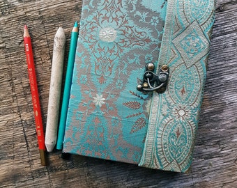 Vintage fabric sketchbook journal 5 by 7 inches. One of a kind blank book with artisan paper pages. Medieval look bronze metal lock closure.