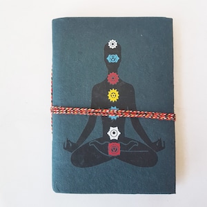 Yoga Aesthetic Lined Journal. Hardcover fabric bound  5x7 inch. Cover Design of Yogi in Lotus Pose with 7 Chakra Energy Center Symbols.