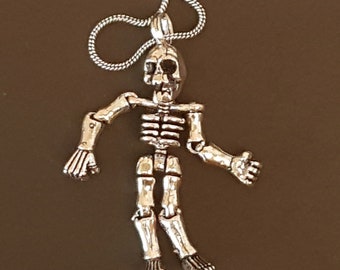 Day of the Dead skeleton pendant necklace on 20 inch chain.  Articulated limb Gothic skeleton puppet pendant. Available in gold or silver.